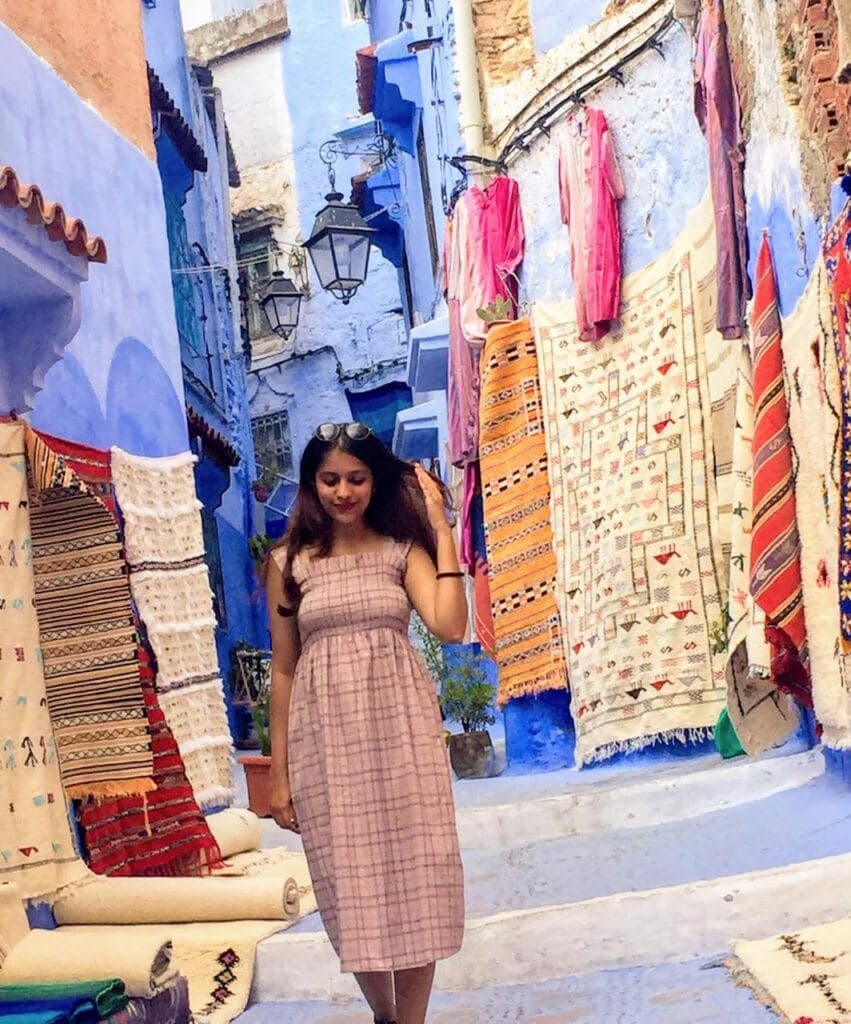 Me in Chefchaouen while traveling to Morocco on a budget