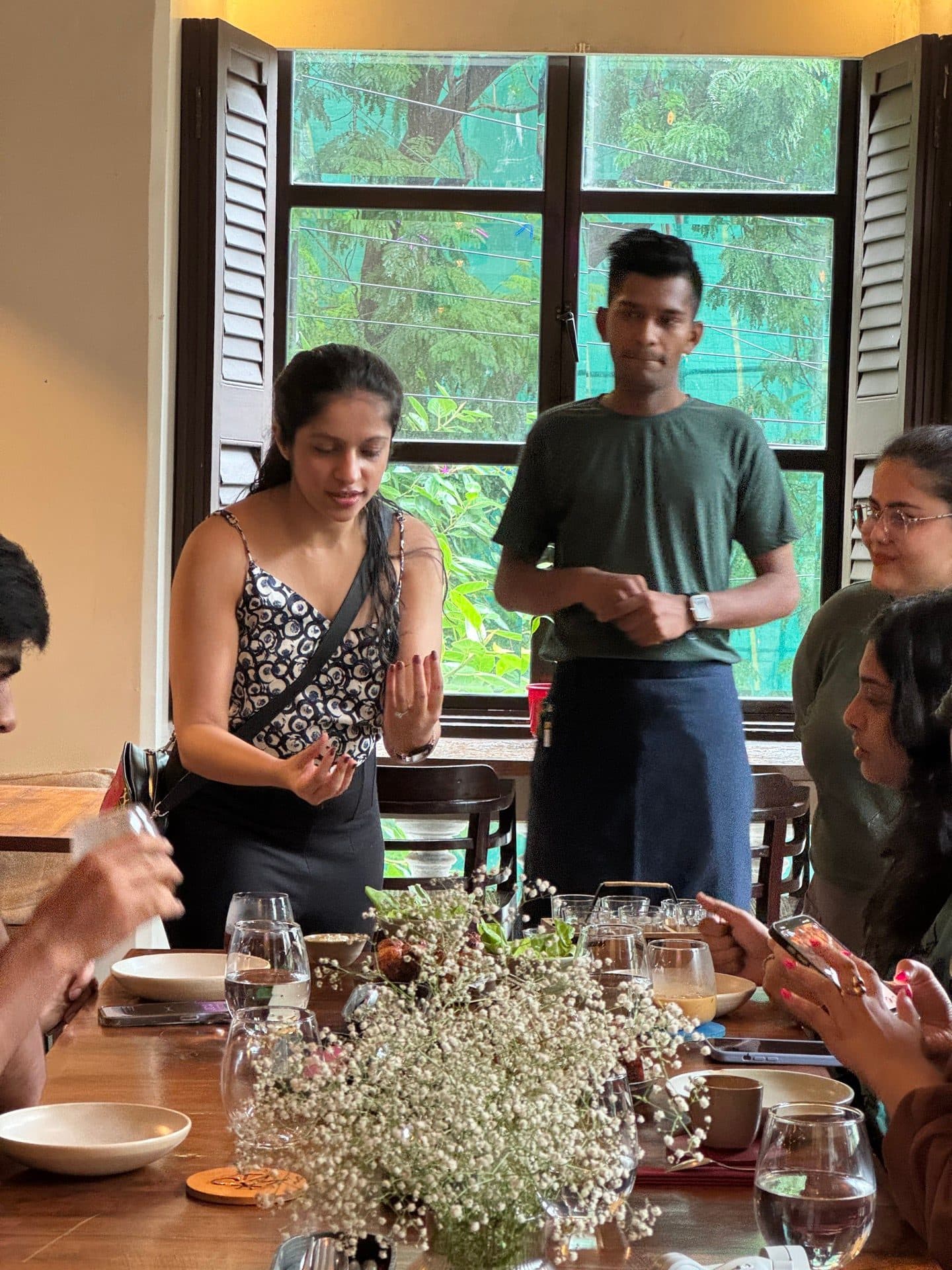 A host walking the group through the tasting menu at a heritage cafe